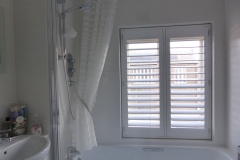 Waterproof Shutters Fitted Over Bath in Bathroom
