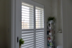 Tall Bathroom Window Fitted with Shutters with Middle Rail