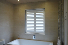 Waterproof Shutters Fitted in Window over Bath in Bathroom