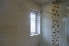 Small Single Window Next to Shower in Bathroom with White Shutter Fitted