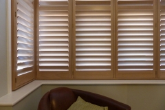 Square Lounge Bay Widow Fitted With Natural Wood Shutters