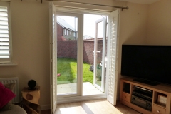 Bi-folding shutters across a door