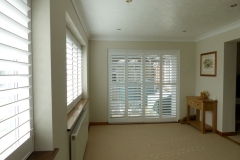 Tracked Shutters On Four Panel Patio Doors