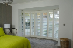Plantation Shutters Fitted onto Large Round Bay Doors in Bedroom