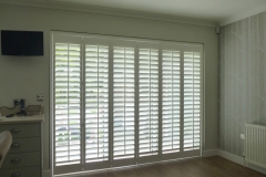 Shutters Mounted on Tracks and Fitted to Balcony Doors in Bedroom