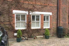 Three Windows With Shutters From Outside The House