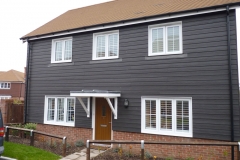 White Shutters Fitted to Large Cladded House