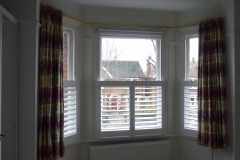 Half Height White Shutters in Angled Bay Window