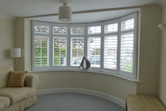 White Plantation Shutters Fitted to Large Round Bay Windows in Living Room