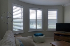 Three Individual Angled Windows in the Lounge Fitted with White Shutters