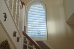 White Wooden Shutters Fitted to Arch Shape Window