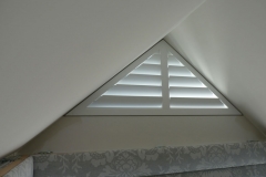 Small Triangle Shape Window with White Wooden Shutters
