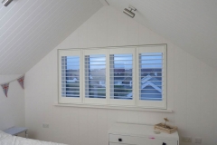 Elite Wood Shutters (Fiji) in a bedroom