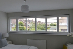Wide bedroom window with shutters