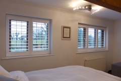 Two Stained Bedroom Windows with White TPost Shutters Fitted