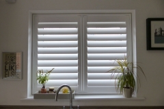 White Tpost Shutters Fitted to Kitchen Window Above the Sink