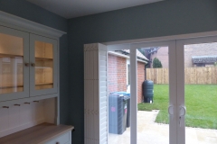 Tracked Bi-Folding Shutters Pushed to Left Side of Wide Patio Doors