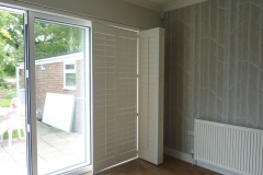 Track Mounted Shutters Partially Closed Over Patio Doors