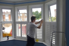 Sam installing shutters on a bay window for 60 minute make over