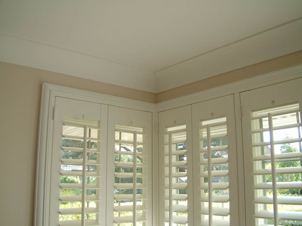 Deco frame shutters fitted around a box bay window