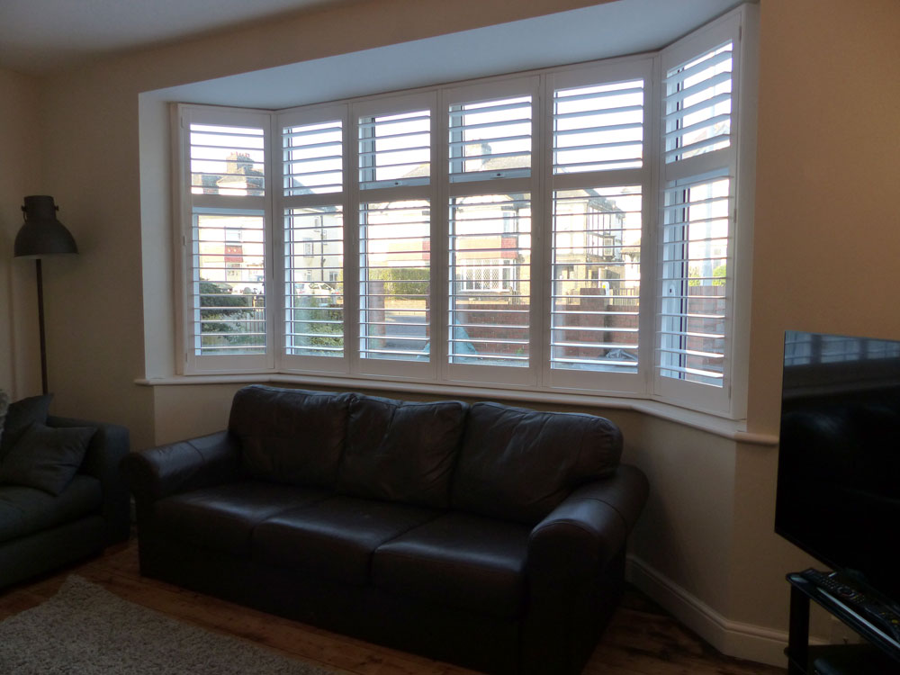 Shutters on Wide Angled Bay Window in Living Room