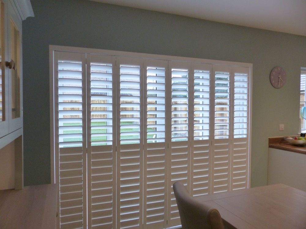 Tracked Plantation Shutter Doors with Split Tilt and Top Louvres Open