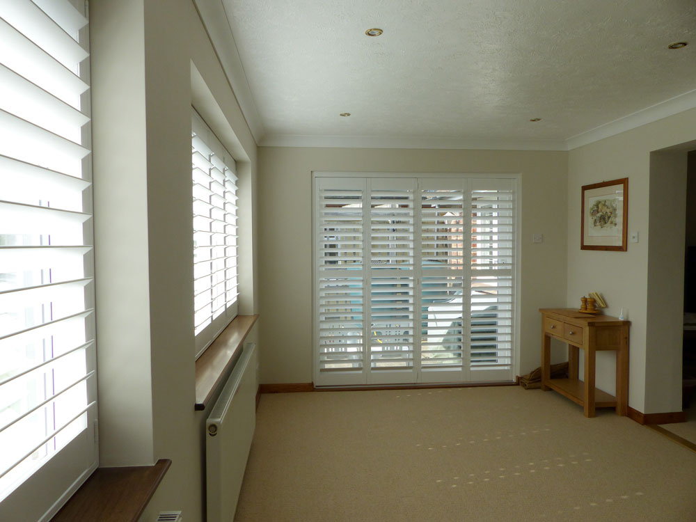 Tracked Shutters On Four Panel Patio Doors
