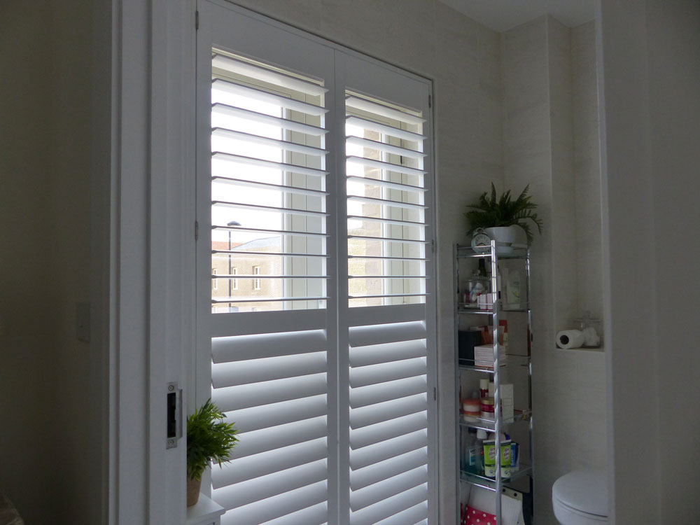 Tall Bathroom Window Fitted with Shutters with Middle Rail