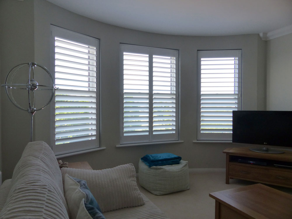 Three Individual Angled Windows in the Lounge Fitted with White Shutters